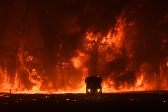 A fire crew is overwhelmed at Orangeville, south-west of Sydney, in December 2019.