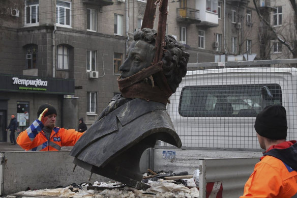 Municipal workers dismantle a monument of Russian writer Alexander Pushkin in the city centre of Dnipro, Ukraine, on December 16, 2022.