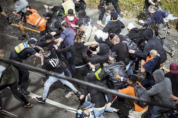 Protesters clash with Victoria Police officers at an anti-lockdown rally in Richmond.
