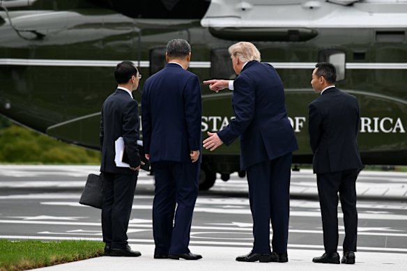 Donald Trump points out a feature of a US Marine Corps helicopter - the type used as Marine One to carry the president. 