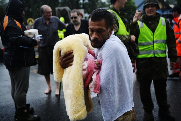 Noel Leon with his three-month-old baby rescued from the  hotel he was staying in with his family.
