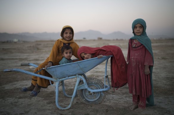 Children pose for a photo as they play in a camp for internally displaced people in Kabul, Afghanistan, on Monday.