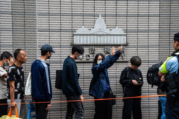 Members of the public wait to enter court to hear a verdict for 47 pro-democracy activists in Hong Kong last month.