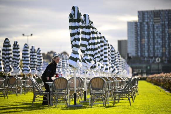 Ground staff set up tables in the Rails Promenade which was formerly an area for car boot picnics. 