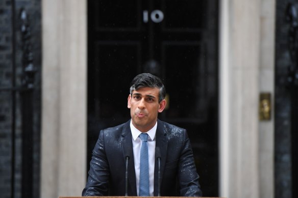 British Prime Minister Rishi Sunak gets drenched as he announces the election on Wednesday.