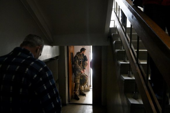 Combat paramedic Vsevolod Dorofeyev during a trauma medical training session stands at a door listening to an air raid siren that warns the citizens of Dnipro to seek shelter. 