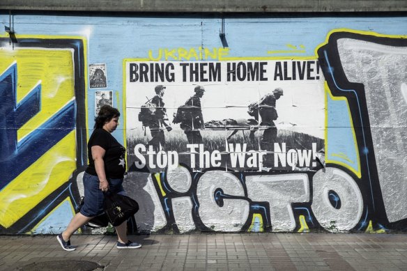 A pedestrian passes an anti-war mural ahead of Ukraine’s Independence Day in Kyiv.