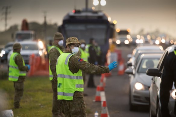 Soldiers assist Victoria Police on a roadside checkpoint on the Geelong Freeway as Melbourne went into lockdown in mid-July.