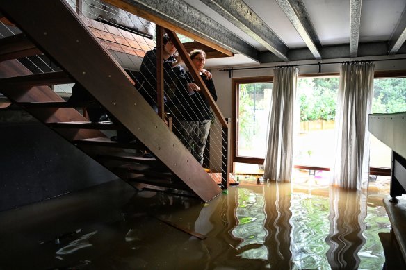 Treacy Bugeja looks at her flooded downstairs. 