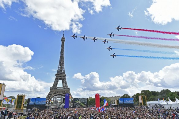 French Elite acrobatic team Patrouille de France flies over the Eiffel Tower during the Olympic Games handover from Tokyo to Paris in 2021.