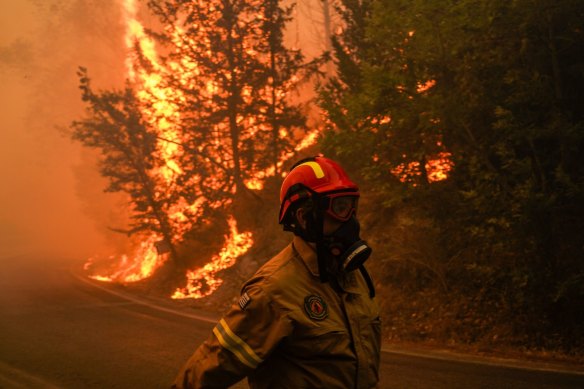 A firefighter works to control a wildfire northeast of Athens, Greece.