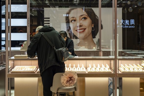 A customer checks out the display at a Luk Fook store in Shanghai.