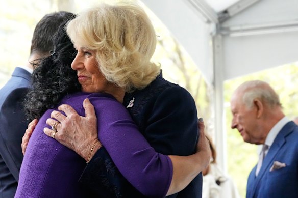 The Queen embraces a relative of a victim of the 9/11 attacks at the memorial.