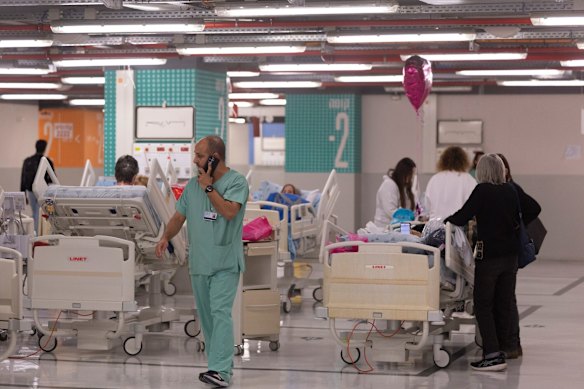 Hospital staff move patients to a parking lot shelter at the Ichilov medical center in Tel Aviv, Israel.