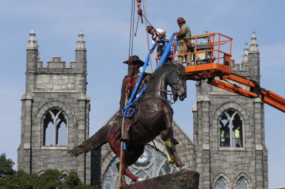 Crews work to remove a statue of Confederate general J.E.B. Stuart from Richmond's Monument Avenue on July 7.