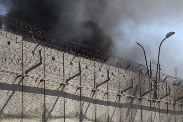 Tyres burning behind the Israeli separation barrier in Ramallah, West Bank.