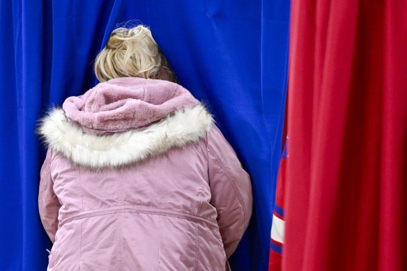 A voter casts their ballot at a polling station inside Pinkerton Academy in Derry, New Hampshire.