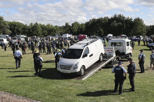 Police enter the makeshift campsite associated with the 'Convoy to Canberra' with camping equipment beginning to get removed and cars towed, at the lawns in front of the National Library of Australia in Canberra on Friday 4 February 20222. fedpol Photo: Alex Ellinghausen