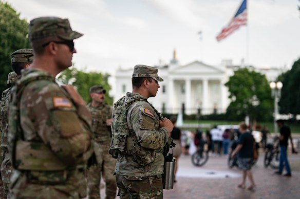 Members of the National Guard after an individual set fire to an American flag in Lafayette Park outside the White House on Monday.