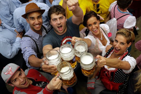 Young people celebrate the opening of the Oktoberfest beer festival in Munich, Germany.