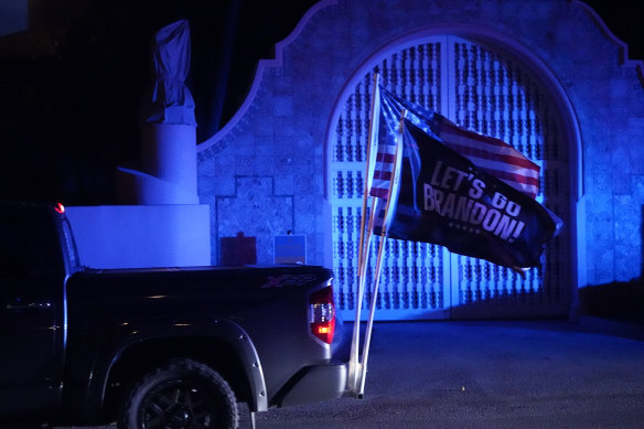 A supporter of Trump drives past his Mar-a-Lago estate, after the news of the raid.