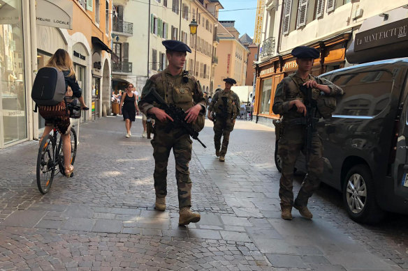 Soldiers patrol a street in Annecy after a knife attack.