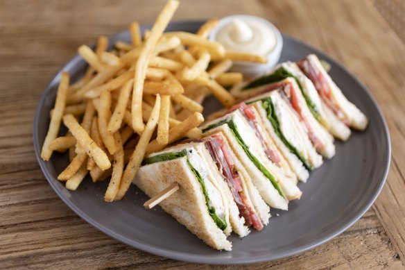 Club sandwich with fries served at The Cosmopolitan in Double Bay, Sydney.