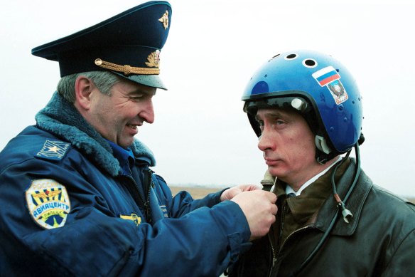 Russian air force general Alexander Kharchevsky adjusts a helmet on Vladimir Putin, then Russia’s Acting President, before he flew into Chechnya in a fighter jet on March 20, 2000. 