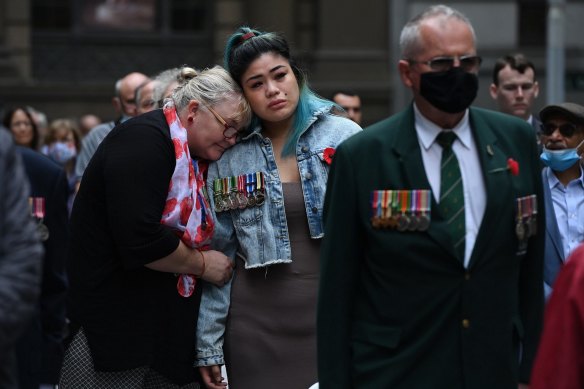 Megan Rull, 29, whose partner, an Afghanistan veteran, took his own life last year, is comforted by Joanne Beavis, from Legacy, at the Cenotaph in Martin Place.