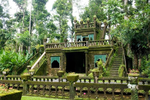 Visit a 1930s castle flanked by gardens and lush rainforest.