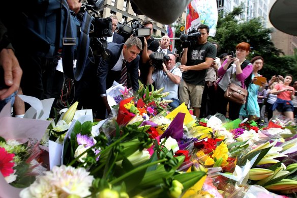 Then NSW Premier Mike Baird lays flowers at Martin Place after the Lindt Cafe siege in 2014.