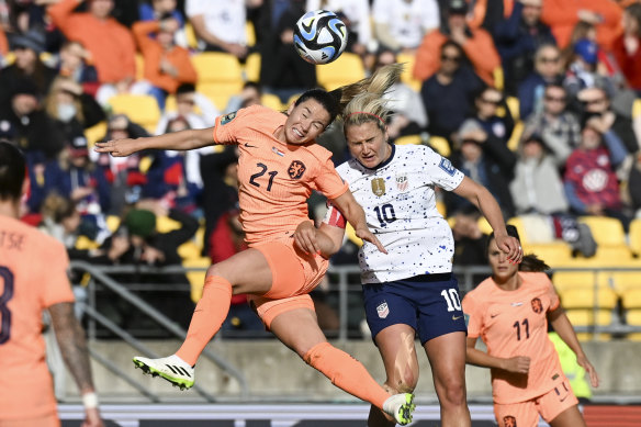Netherlands’ Damaris Egurrola, left, and United States’ Lindsey Horan compete to head the ball.