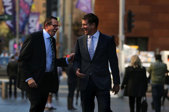 Rob Whitfield, left, became NSW Treasury chief under then-premier Mike Baird, right.