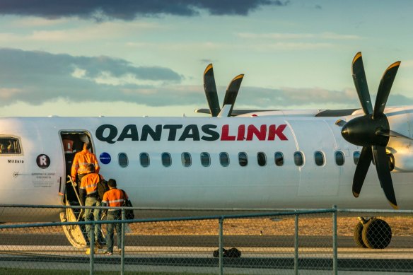 Fly-in-fly-out workers board a plane.