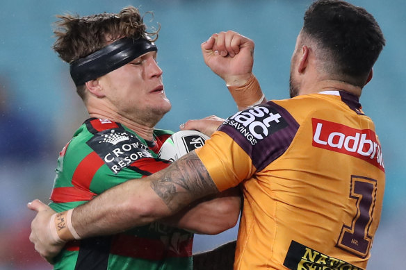 Broncos fullback Darius Boyd blocks Rabbitohs forward Liam Knight on Friday night.