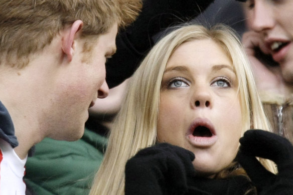 Prince Harry, left, talks to his then- girlfriend Chelsy Davy, who was born in Zimbabwe, before the international rugby match between England and South Africa at Twickenham stadium in 2008.