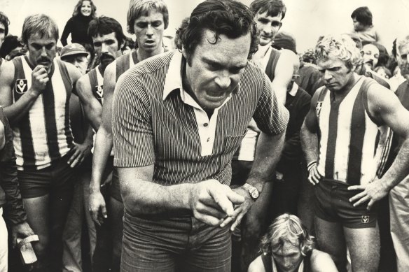 Ron Barassi giving his North Melbourne team a serve.