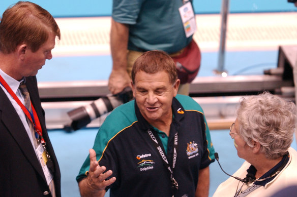 Australian swimming head coach Don Talbot (centre) complains to officials about FINA’s decision. 