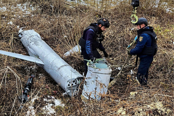 Ukrainian pyrotechnists examine an X-55 Russian aviation cruise missile that was shot down in Kyiv on Thursday.