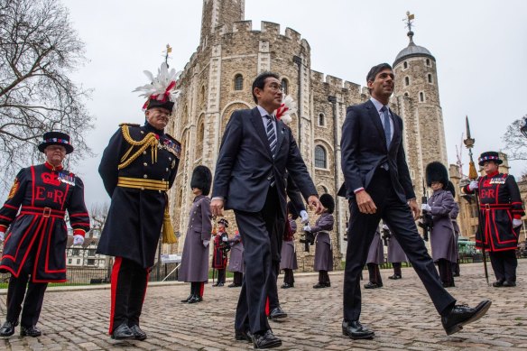 Japanese Prime Minister Fumio Kishida, centre, and Britain’s PM Rishi Sunak, right, walk through the Tower of London after signing a defence agreement.