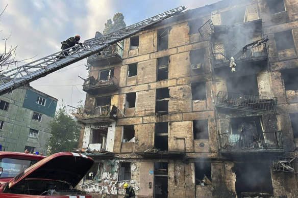 Emergency workers respond to the aftermath of a Russian missile strike in Kryvyi Rih.