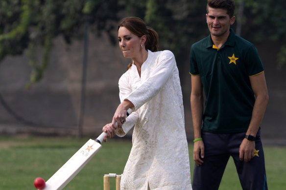 The competetive Princess Kate, Duchess of Cambridge, bats as Pakistani cricketer Shaheen Afridi looks on.