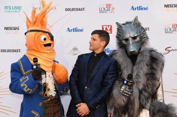Osher Gunsberg (centre) and characters from the 'The Masked Singer' arrive at the 2019 Logie Awards.
