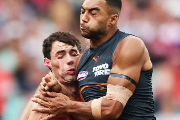 Tom McCartin of the Swans is bumped by Callum M. Brown of the Giants.