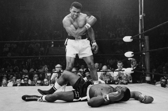 Heavyweight champion Muhammad Ali, then known as Cassius Clay, stands over fallen challenger Sonny Liston in 1965.