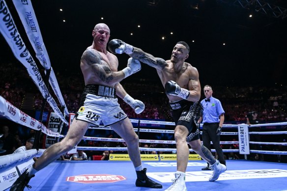 Sonny Bill Williams (right) takes the fight to Barry Hall.