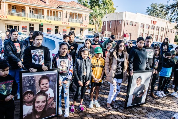 Loved ones hold photos at the start of the inquest into Gordon Copeland’s death.