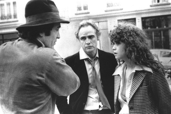 In this 1972 file photo originally provided by United Artists, Director Bernardo Bertolucci (left) Marlon Brando and Maria Schneider are shown during the filing of <em>Last Tango in Paris</em>.