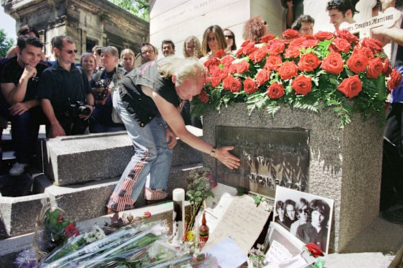 A tourist at Morrison’s grave in 2001, for the 30th anniversary of the singer’s death.