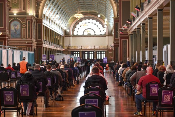 People receiving the AstraZeneca COVID-19 vaccine at the Melbourne Exhibition Centre vaccination hub in August 2021.